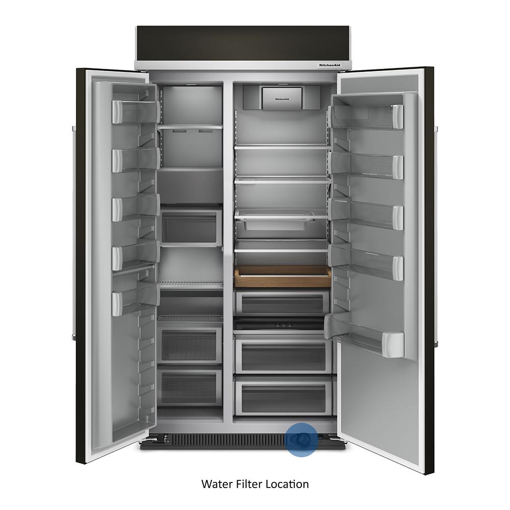 Built-in side-by-side refrigerator with open doors showing adjustable shelves and storage compartments from KitchenAid Appliances collection