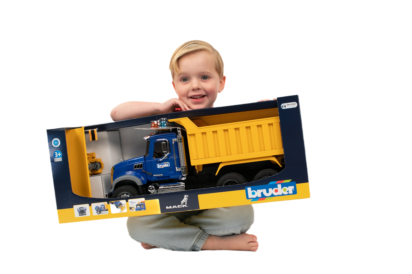 Child holding detailed blue and yellow Mack Granite toy dump truck with plow for tools and home improvement play