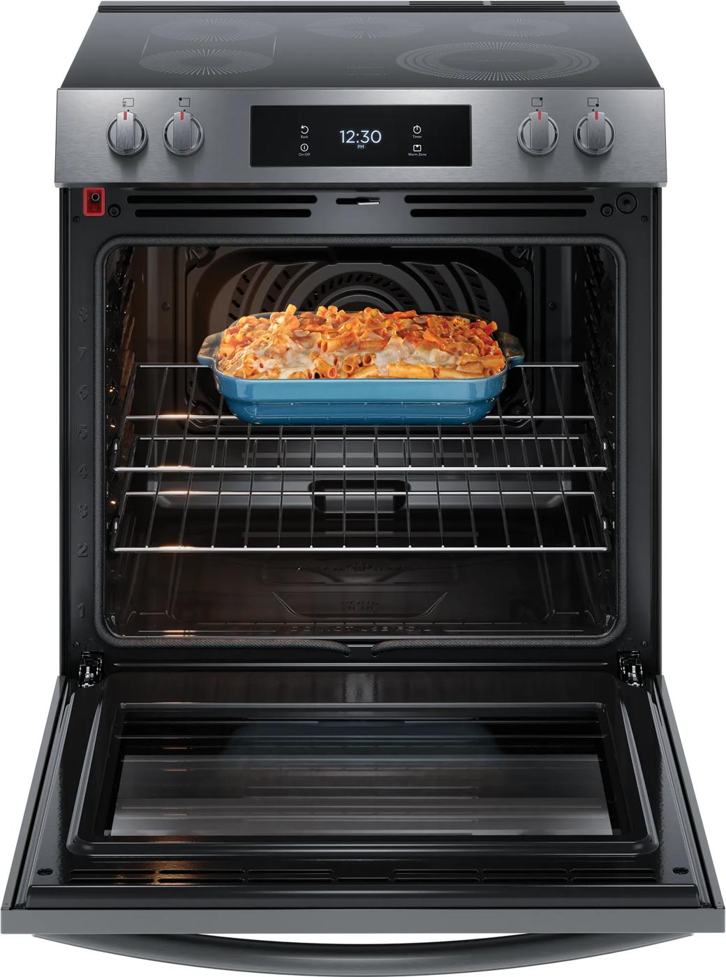 Stainless steel front control electric range with convection oven baking pasta in blue casserole dish in kitchen appliances collection