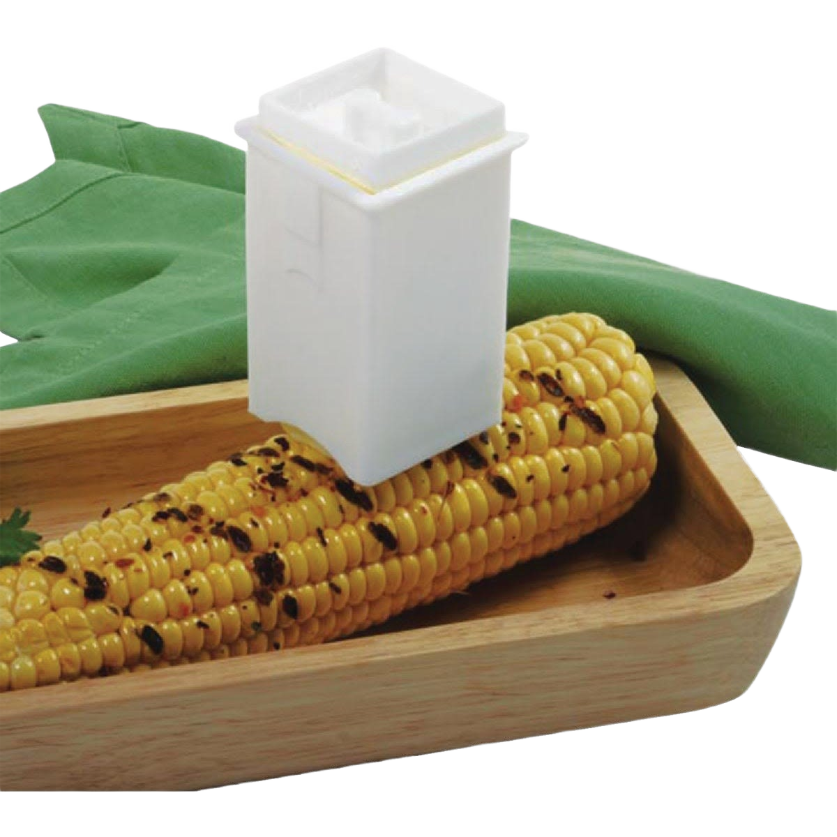 White BPA-free plastic corn butter spreader resting on grilled corn in wooden tray for kitchen gadgets collection