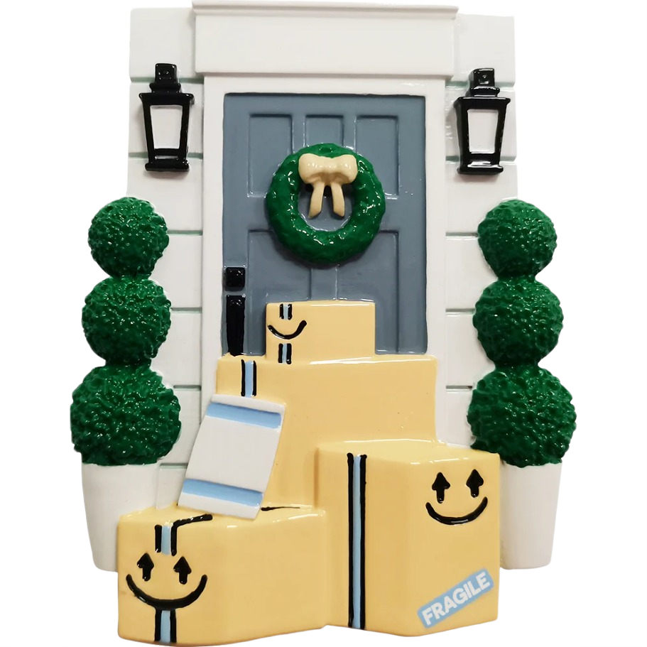 Holiday ornament showing gray door with green wreath and stacked delivery boxes for Christmas decor under $50