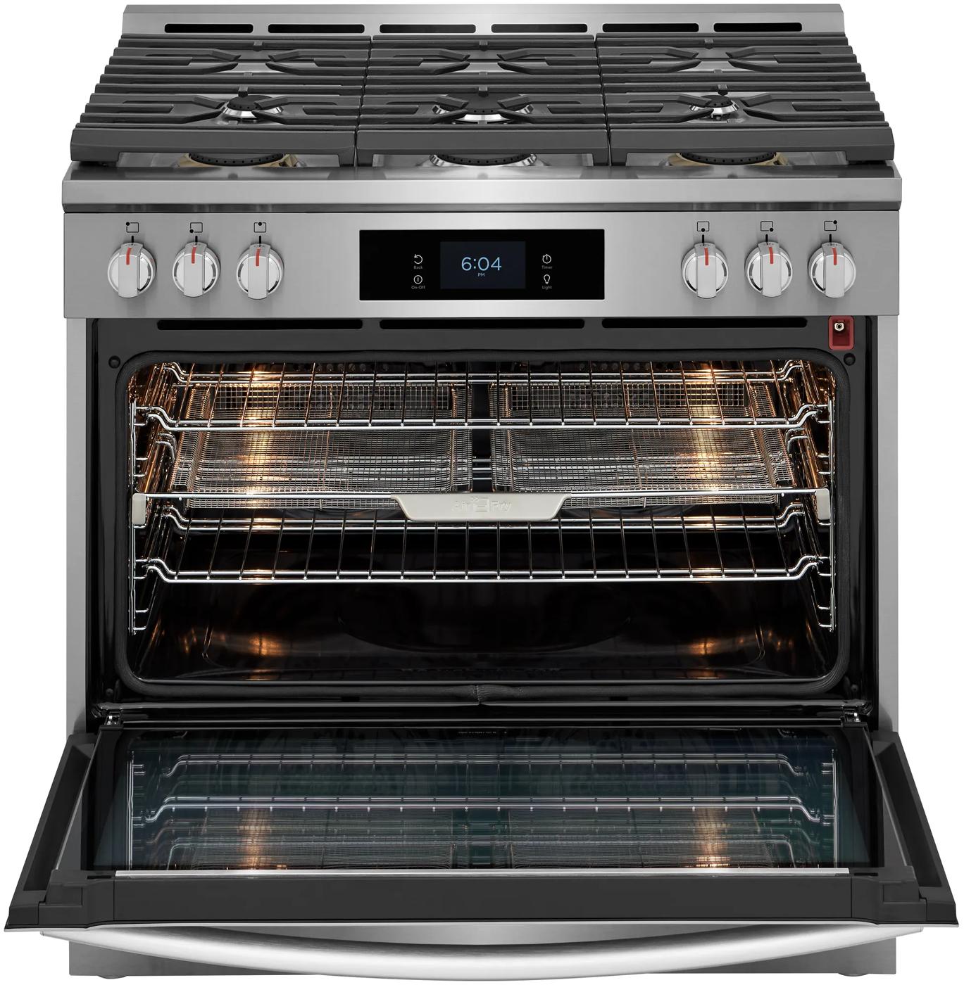 Stainless steel 36-inch dual-fuel range with six burners, digital display, and open oven with racks lit inside