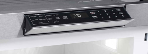Close-up of digital control panel with touch buttons and LED clock on stainless steel microwave drawer in kitchen appliances collection