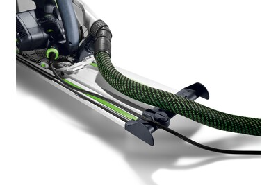 Close-up of Festool track saw attached to a guide rail with dust extraction hose for precise woodworking tasks