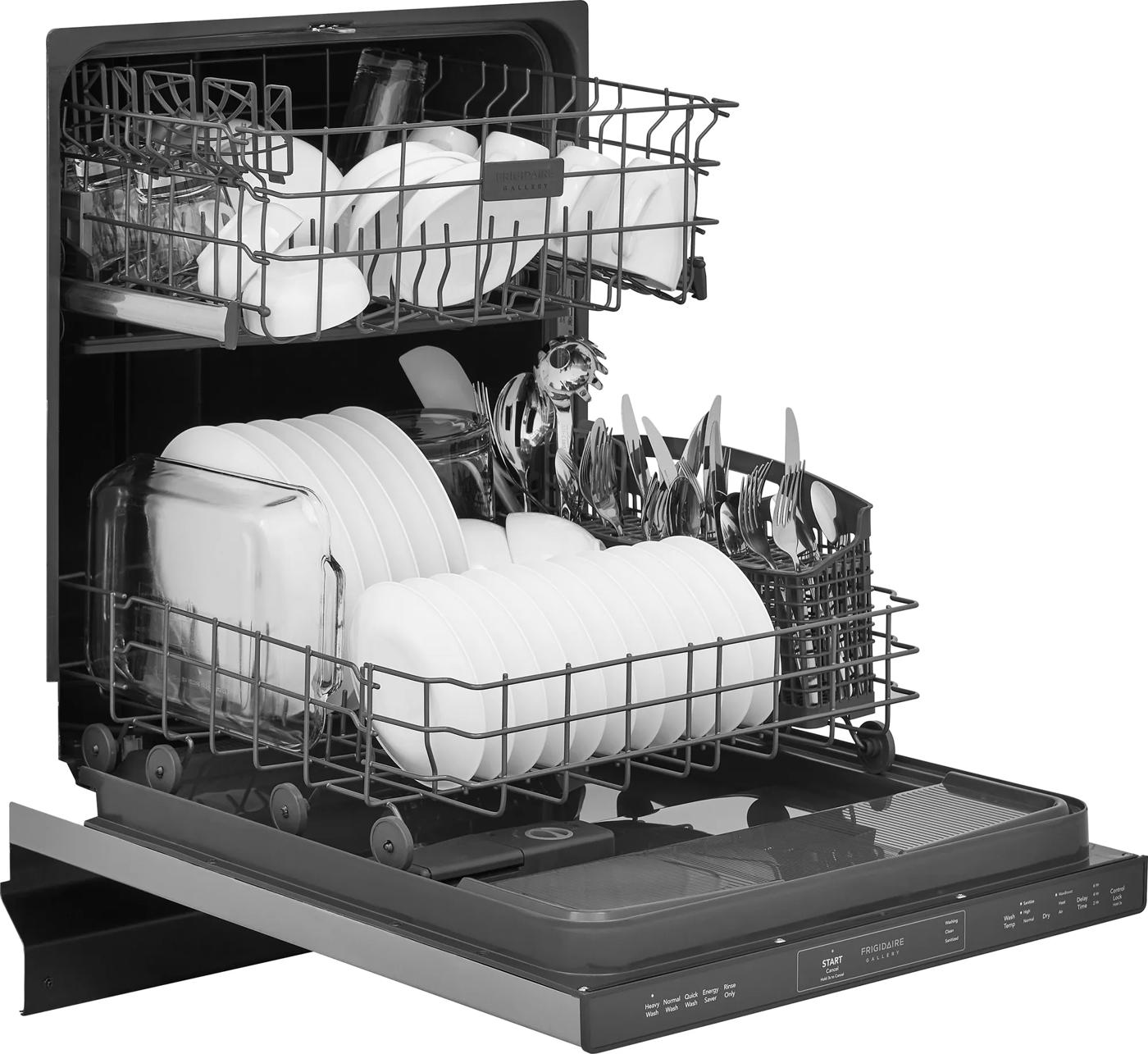 Open built-in dishwasher with fully loaded racks of white dishes and utensils in kitchen appliances collection