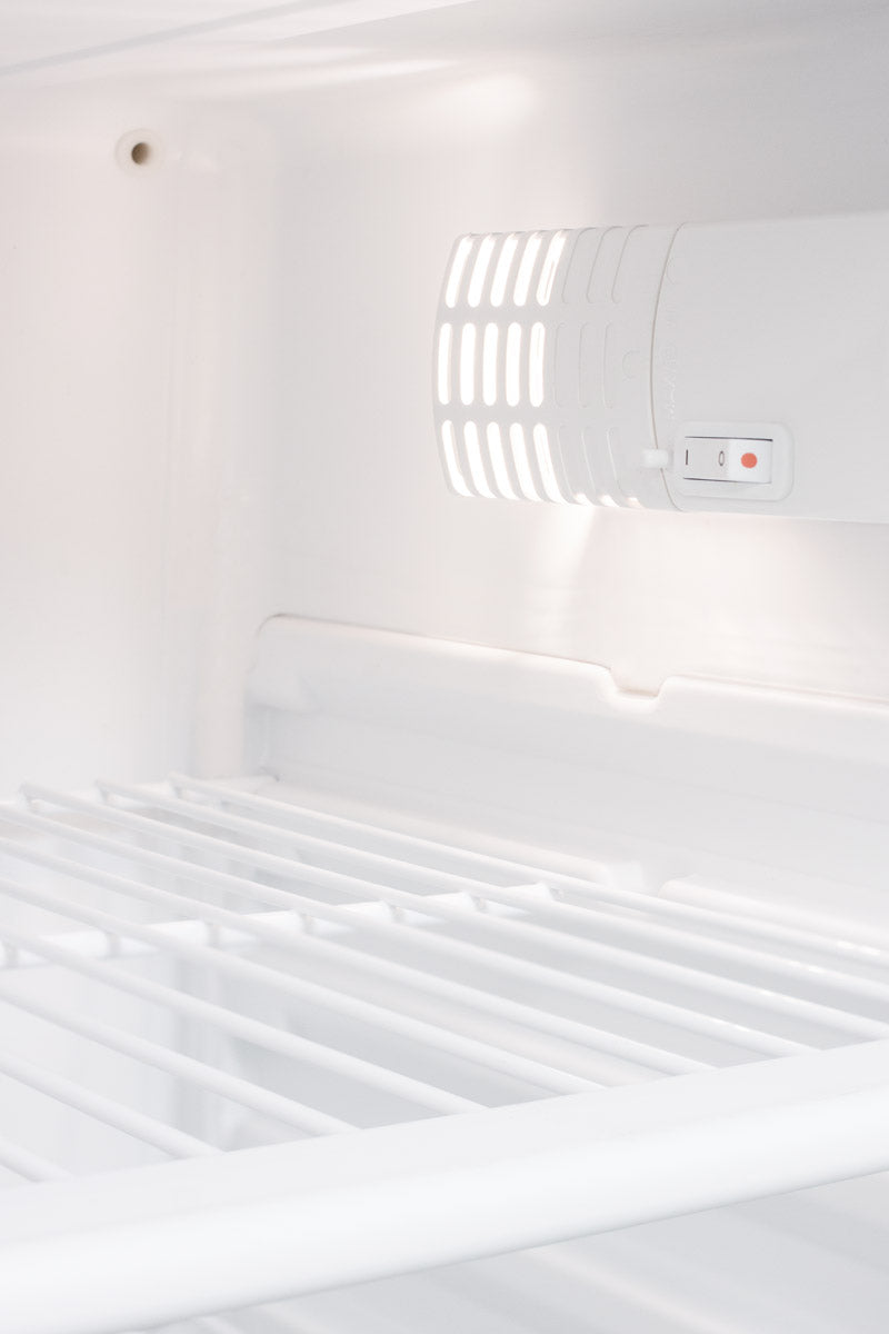 Interior view of white wire shelving and vent with control switch inside a 24" built-in all-refrigerator for appliances collection