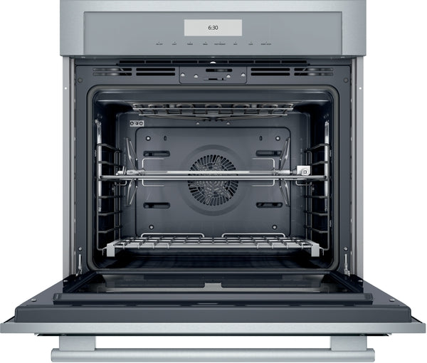 Open stainless steel single wall oven interior with convection fan and adjustable racks from Thermador appliances collection