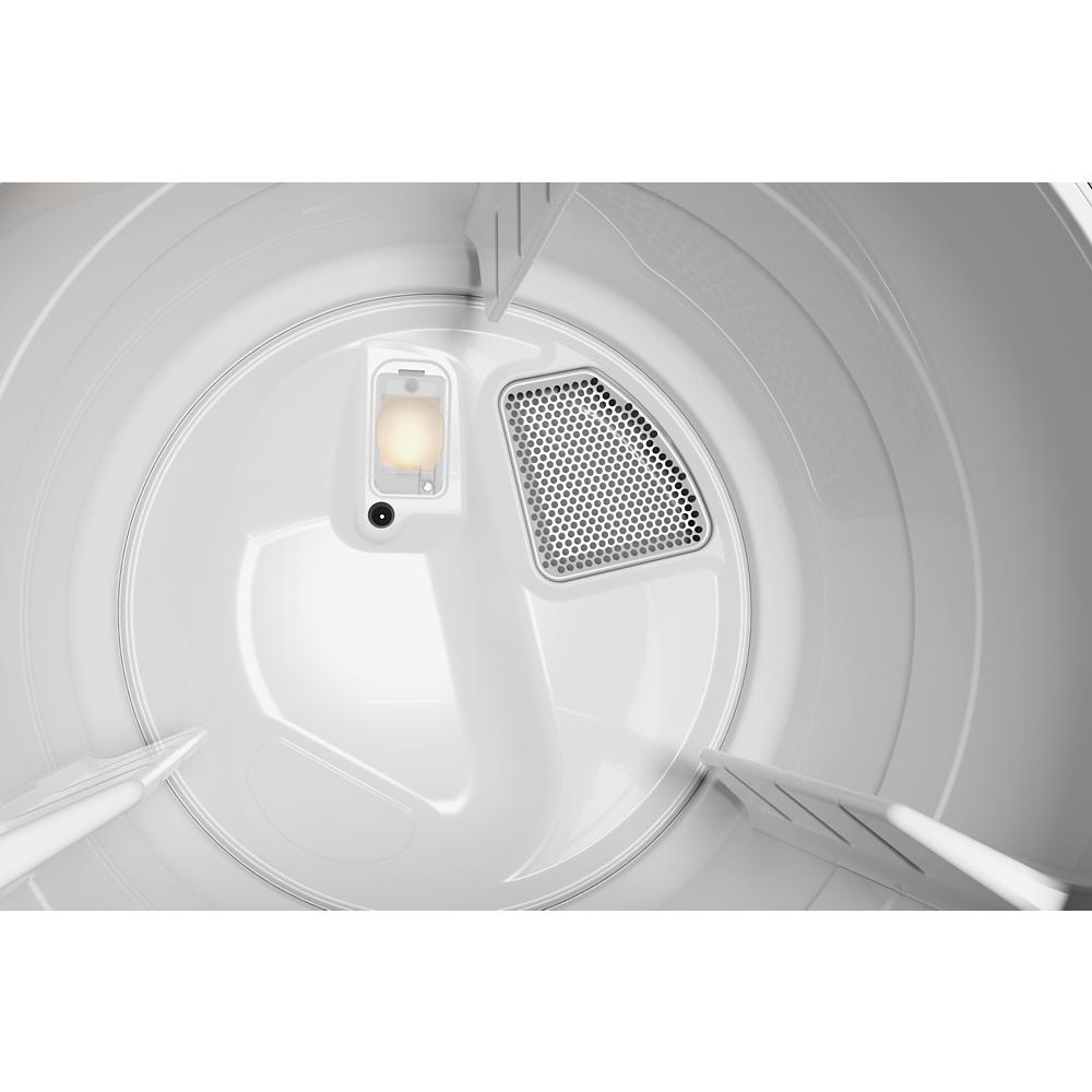 Interior drum of white top load electric dryer showing lint filter and interior light detail