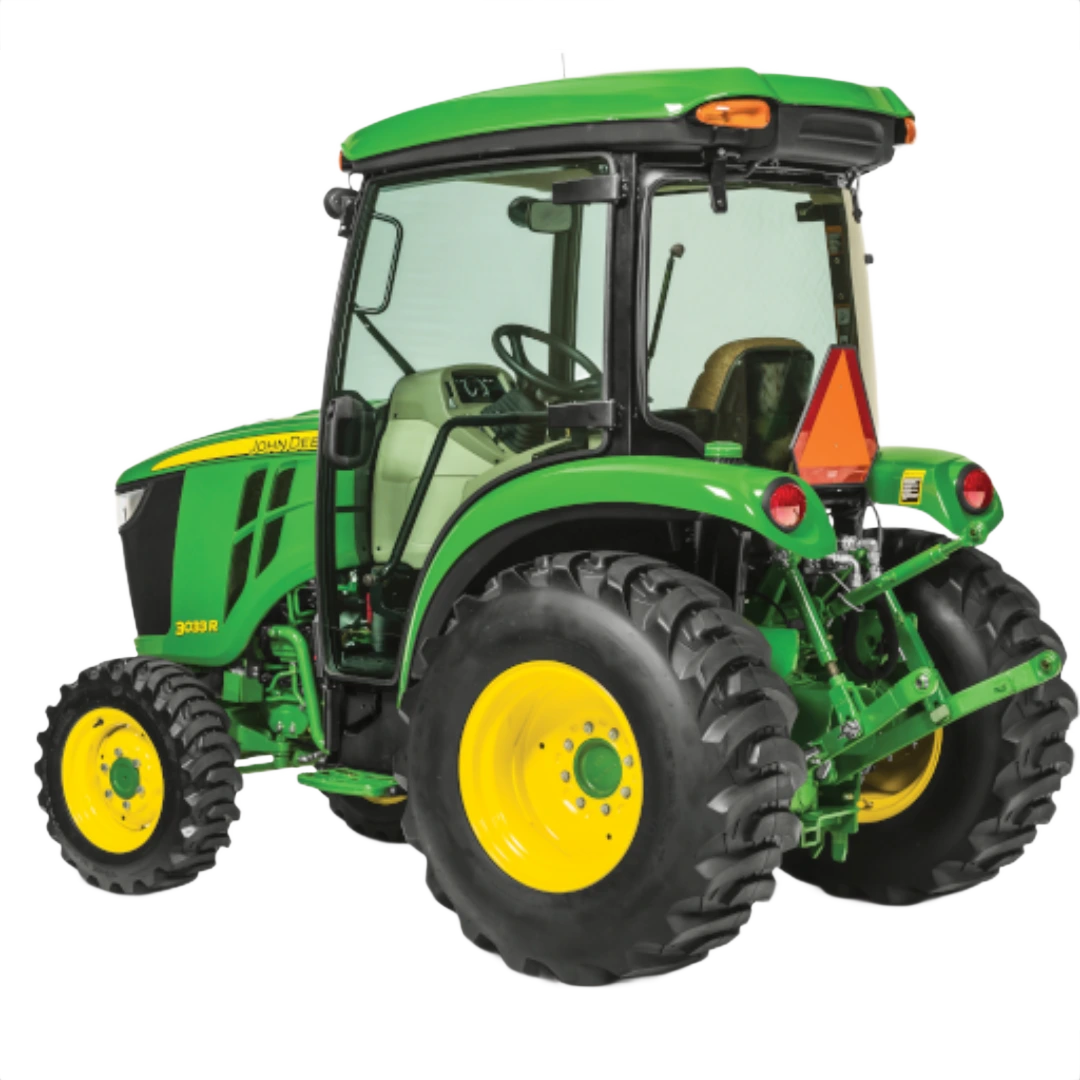 Rear three-quarter view of John Deere 3033R Compact Tractor with ComfortGard cab, featuring green body, yellow wheels, and rugged tires in Outdoor Power Equipment at Hartville Hardware