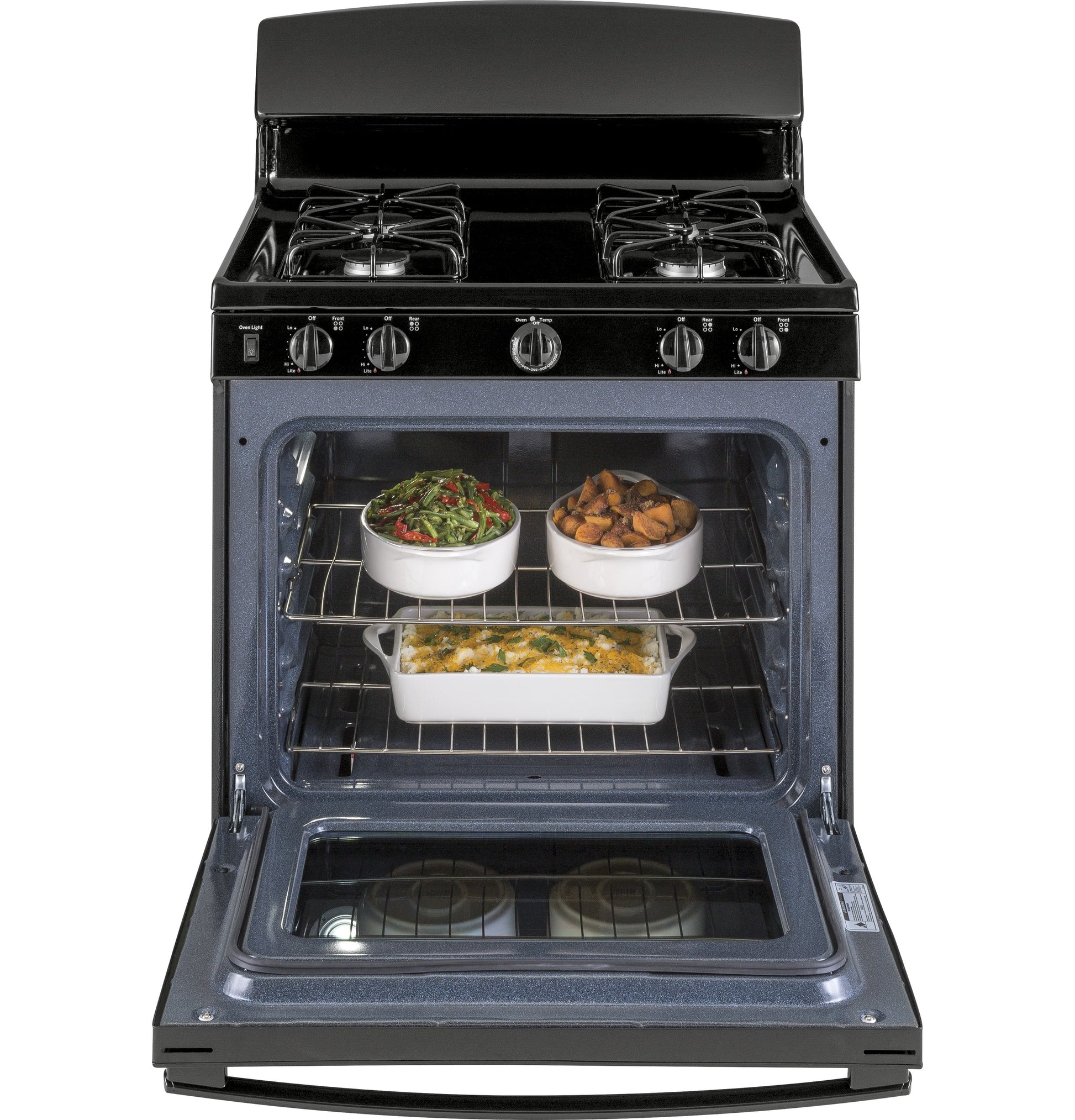 Black gas range with four burners and oven door open showing three dishes inside in Ranges and Kitchen collections