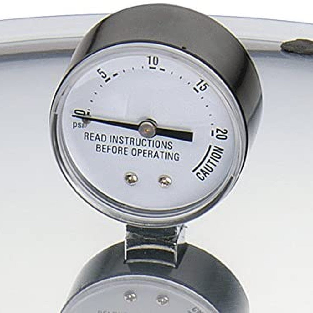 Close-up of a pressure gauge on a 16-quart aluminum pressure cooker with caution and instruction markings