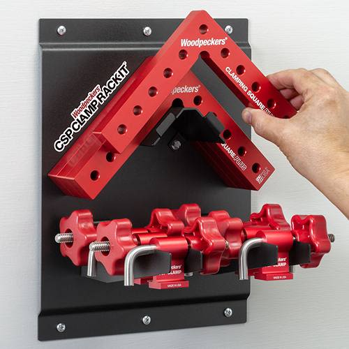 Wall-mounted rack organizing red aluminum clamping squares and clamps for woodworking and home improvement tools