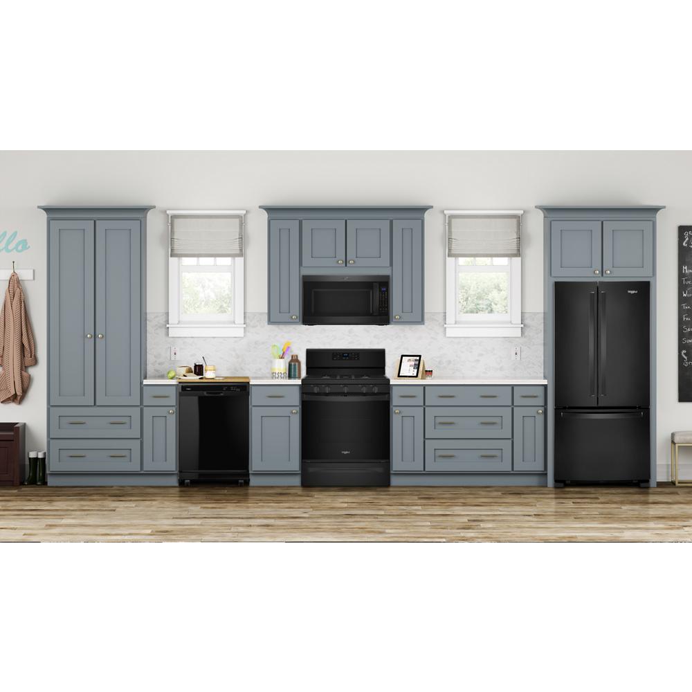 Modern kitchen with blue cabinetry, black appliances including dishwasher, stove, microwave, and refrigerator in home improvement setting
