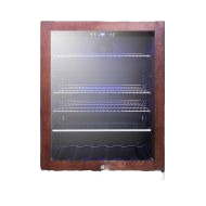 Built-in beverage cooler with tinted glass door, wood frame, adjustable metal shelves, and front ventilation in appliance setting