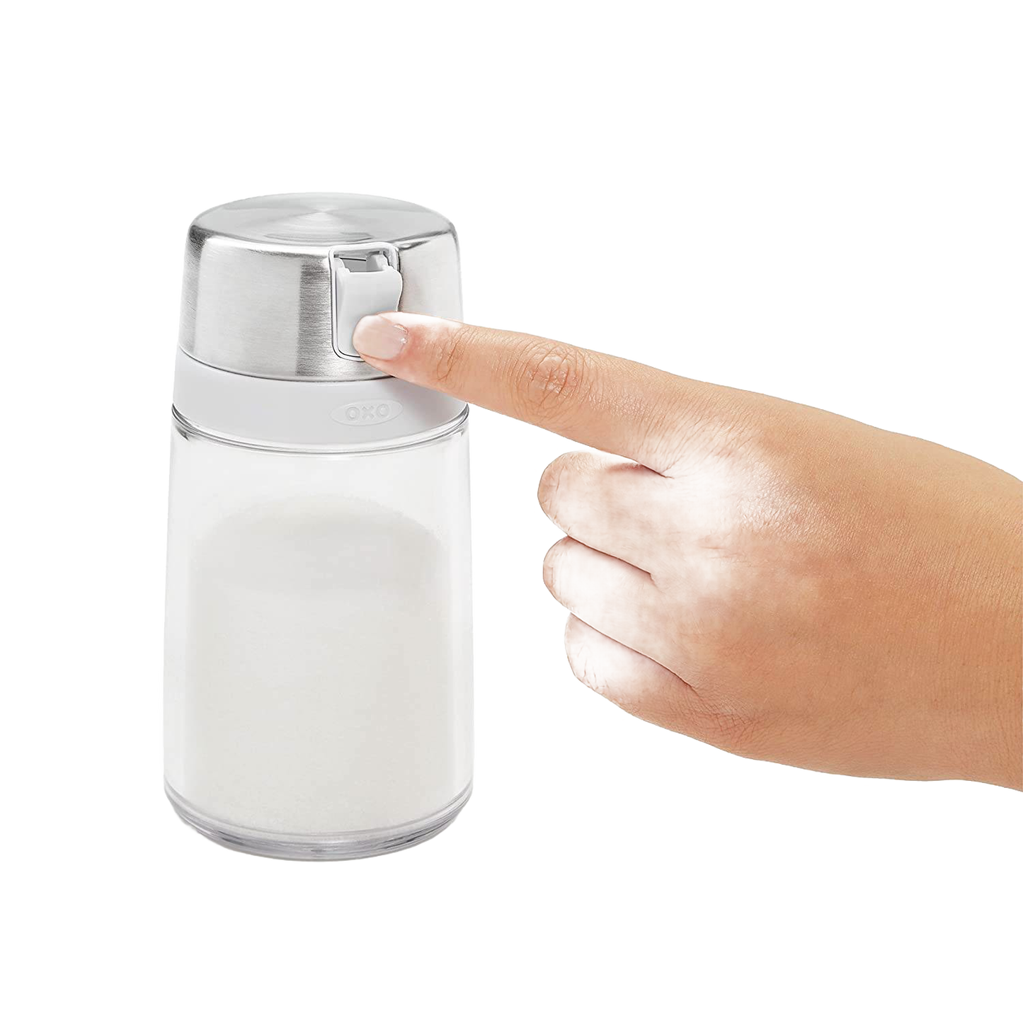 Hand pressing stainless steel top on clear sugar dispenser with white grip for kitchen storage and organization