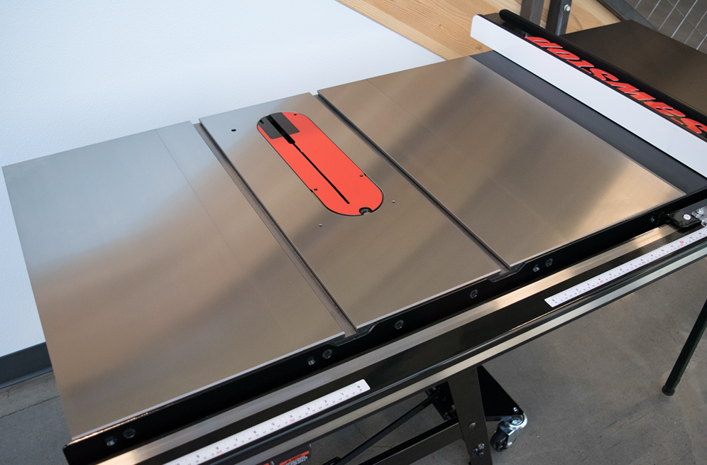 Stainless steel tabletop with integrated red throat plate for 10-inch contractor saw in woodworking power tools collection