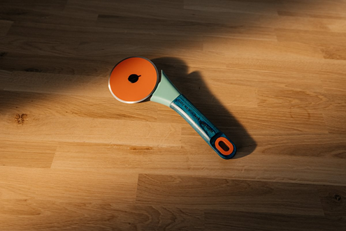 Limited edition pizza cutter with orange wheel and green handle designed for precision cutting in home kitchens