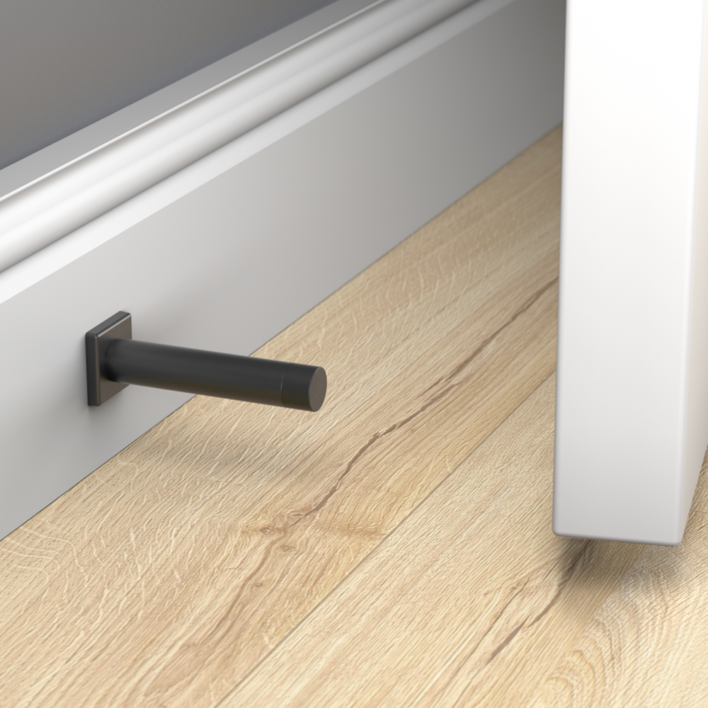 Matte black aluminum door stop with reed pattern installed on wall to protect baseboards in door accessories collection under $50