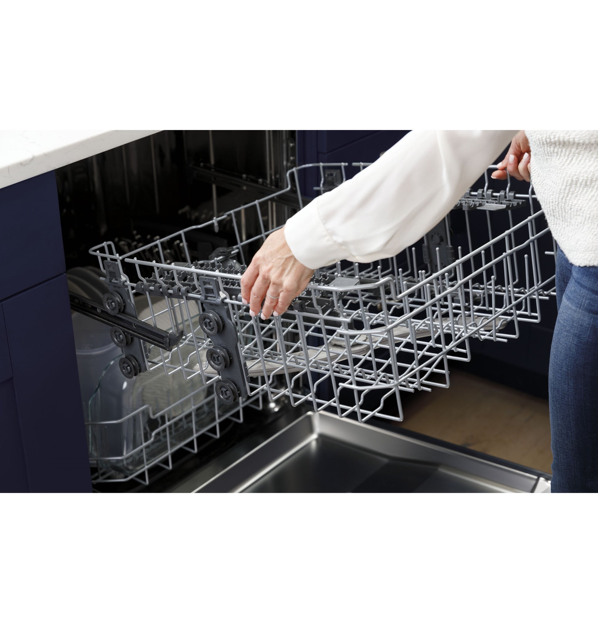 Person removing upper rack from energy star dishwasher in modern kitchenware setting