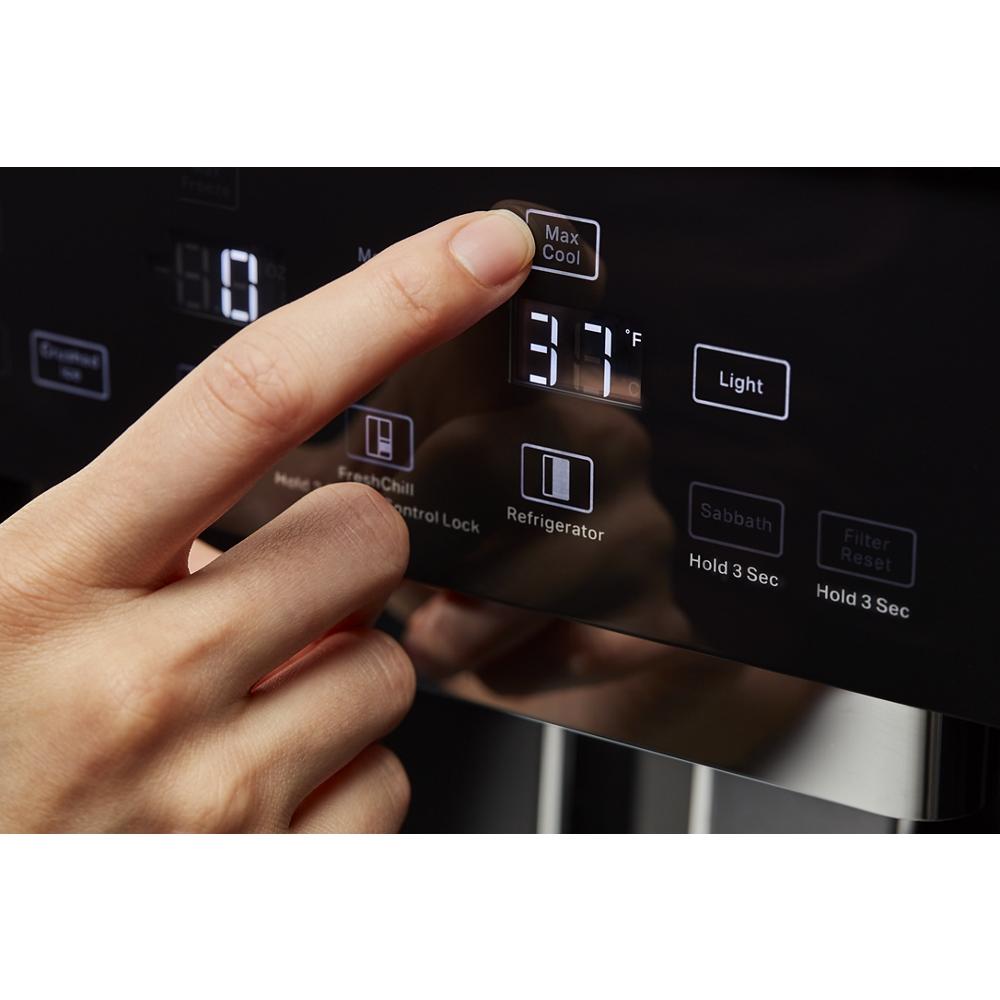 Close-up of hand pressing Max Cool button on digital control panel of built-in side-by-side refrigerator display