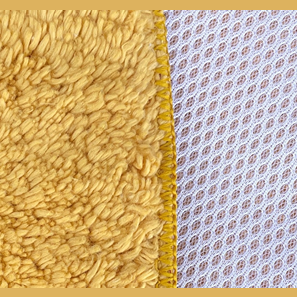 Close-up of mustard yellow cotton chenille towel with white nylon mesh backing from Kitchen & Kitchenware under $50 collection
