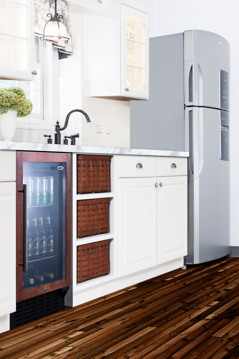 18-inch built-in beverage center with glass door, wood frame, black handle, and illuminated interior in kitchen setting