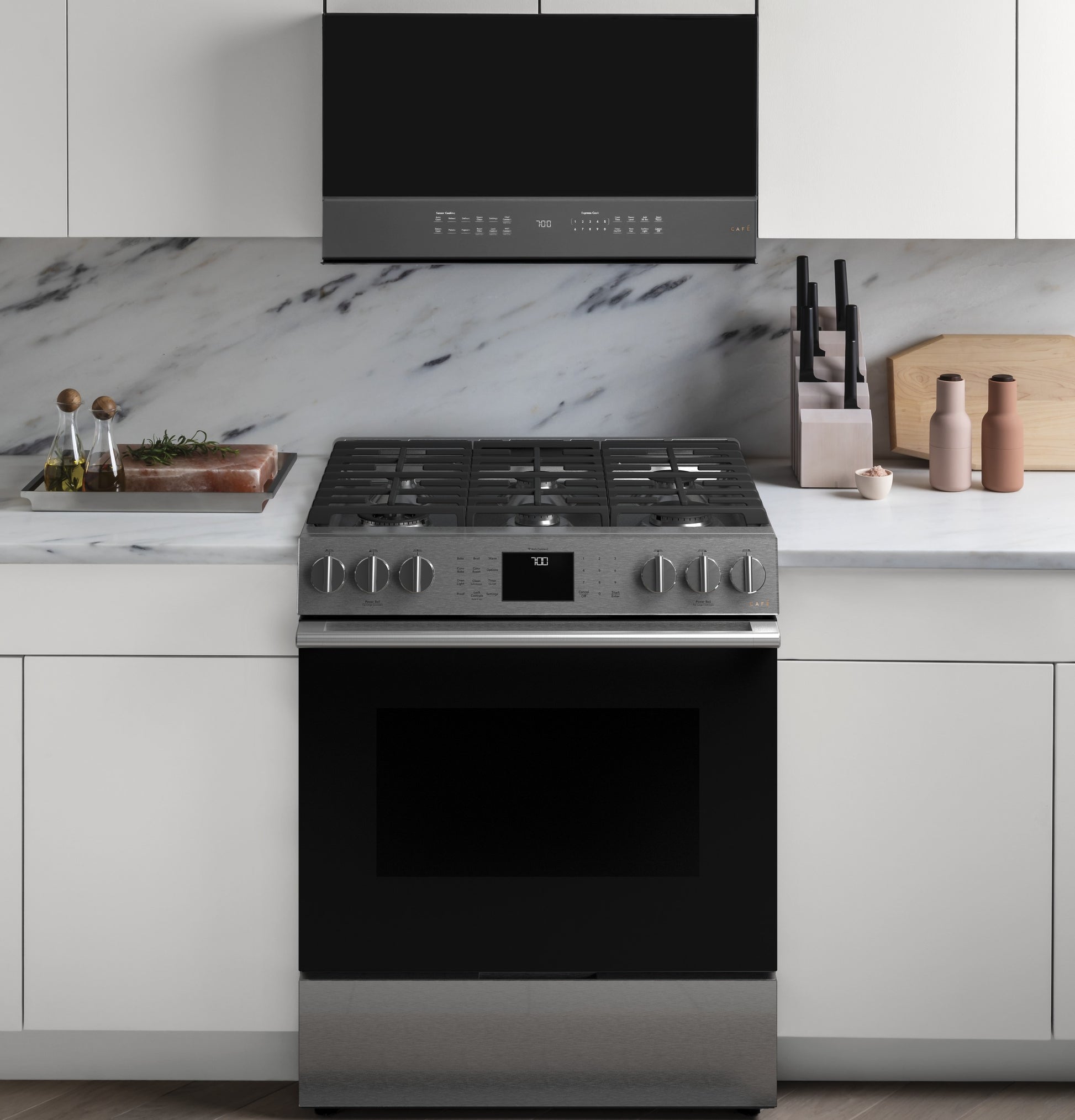 Front view of platinum gas range with convection oven, six burners, and touch control display in modern kitchen setting