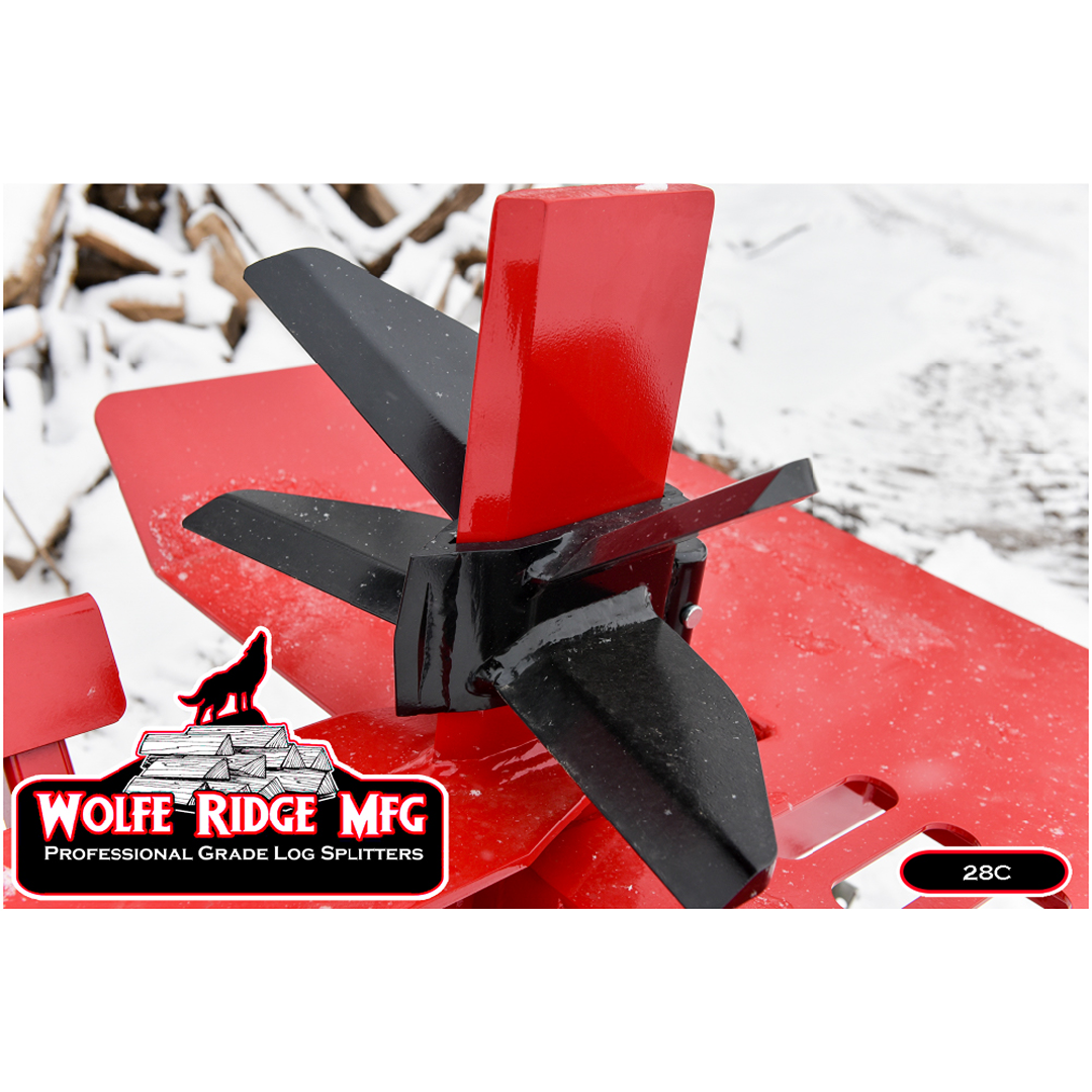 Close-up of steel splitting wedge and push block on red Wolfe Ridge log splitter with snowy woodpile in background outdoors