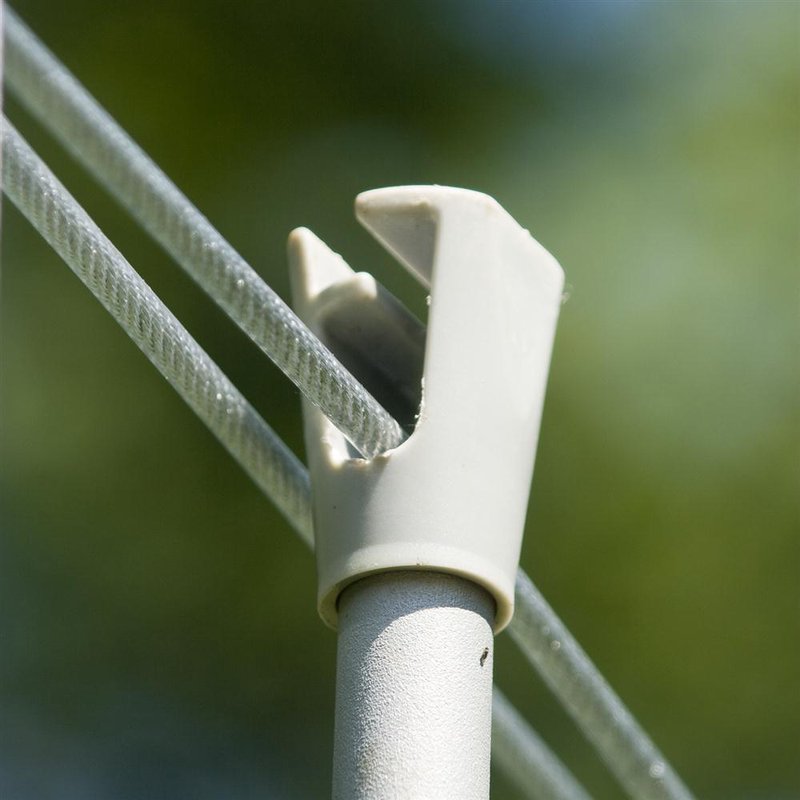 Close-up of durable white plastic clothesline prop holding clear cords, ideal for storage and organization under $50 collections