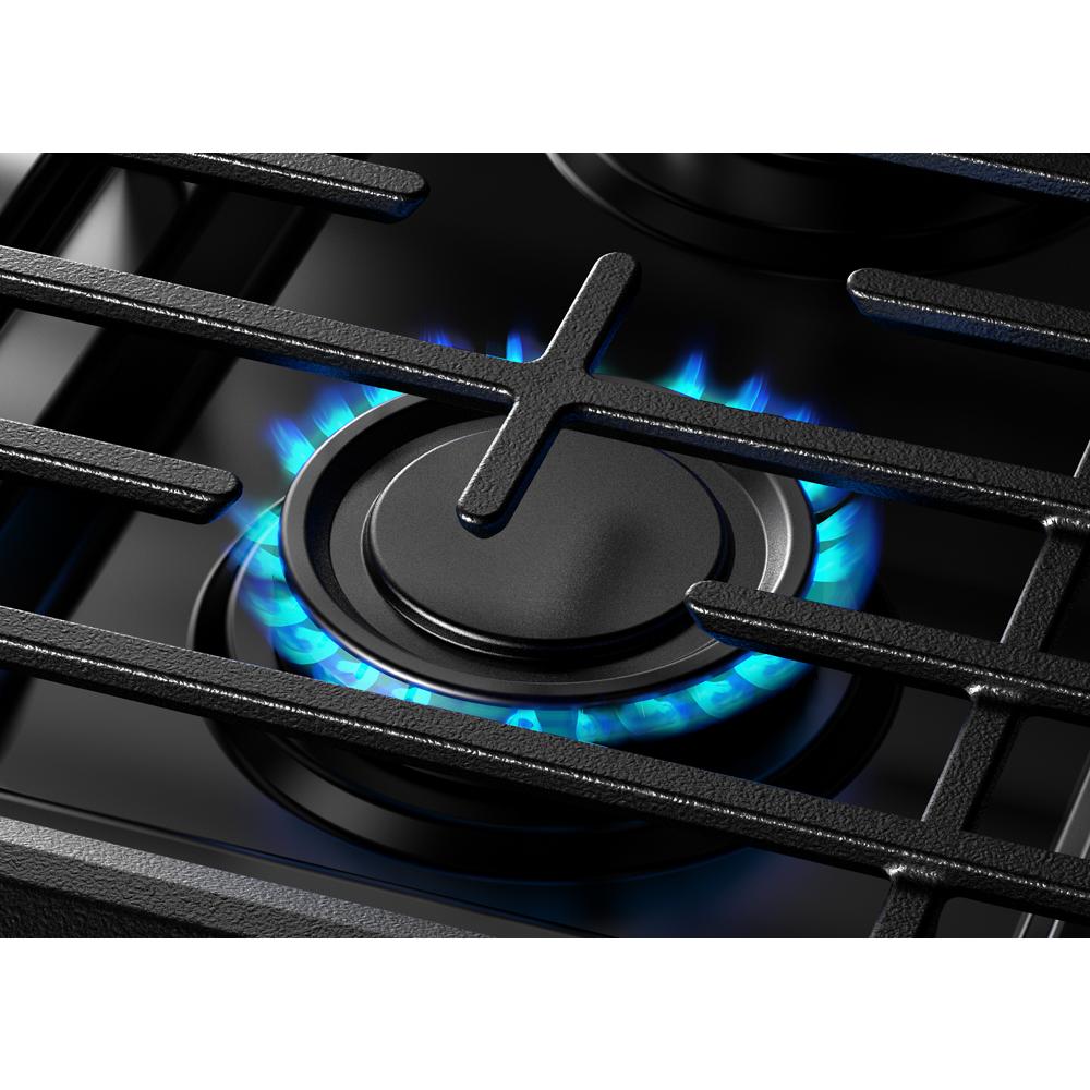 Close-up of a black gas burner with blue flame and cast iron grates from a kitchen range in Appliances and Ranges collections
