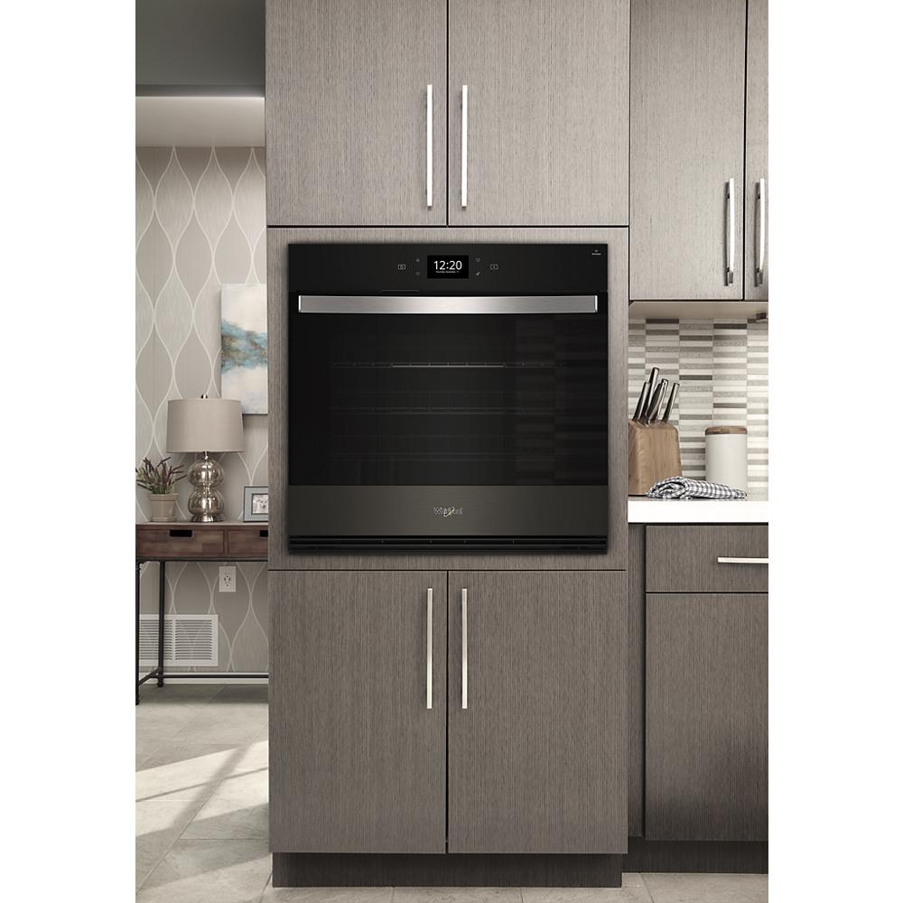 Built-in black and stainless steel smart wall oven with digital display integrated into gray kitchen cabinetry from Wall Ovens collection