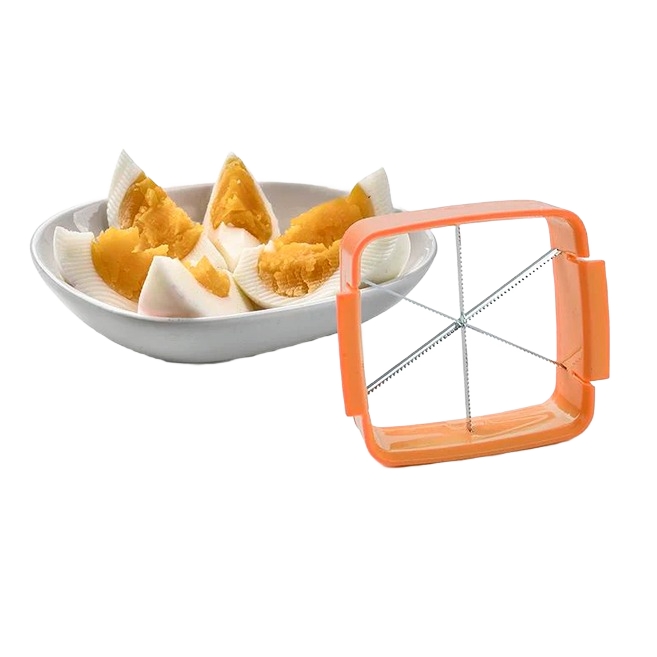 Orange handheld egg slicer with stainless steel blades alongside halved boiled eggs on white dish under $50 kitchenware