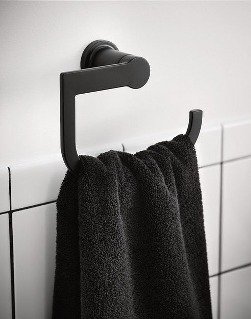 Matte black hand towel ring mounted on white tiled wall holding a dark textured towel for home improvement use