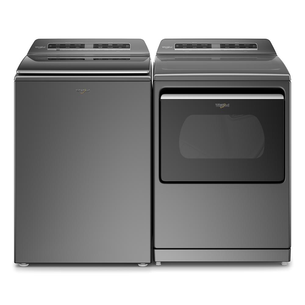 Dark gray Whirlpool top load washer and matching gas dryer with digital controls in modern laundry appliances setting
