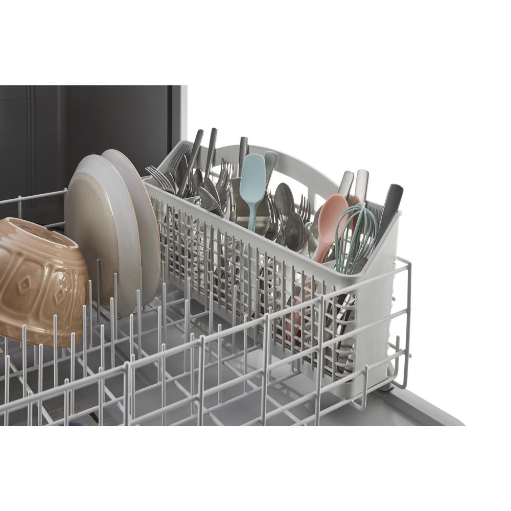 Cutlery and small kitchen tools organized in dishwasher basket inside modern kitchen appliance rack