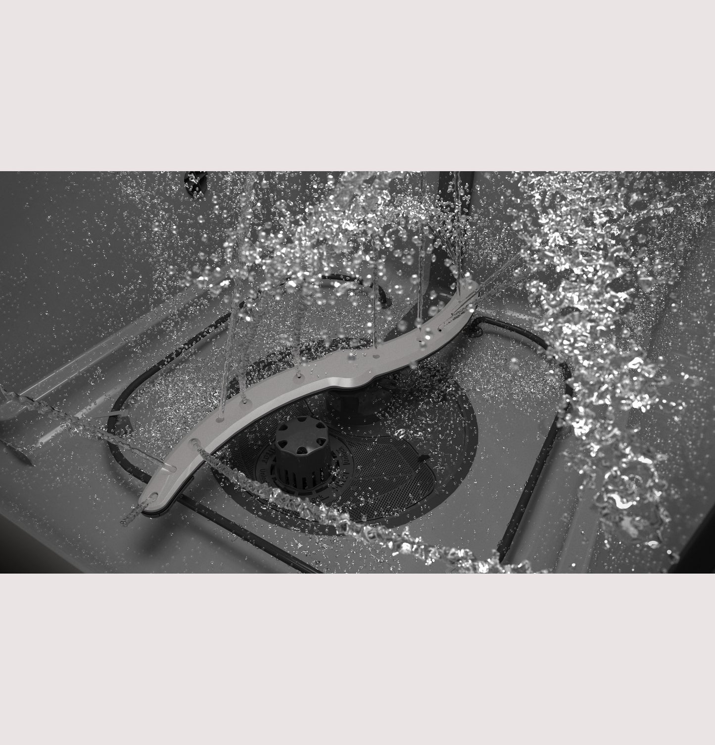 Close-up of water spraying from dishwasher spray arm inside dark-colored dishwasher tub in kitchen appliances collection
