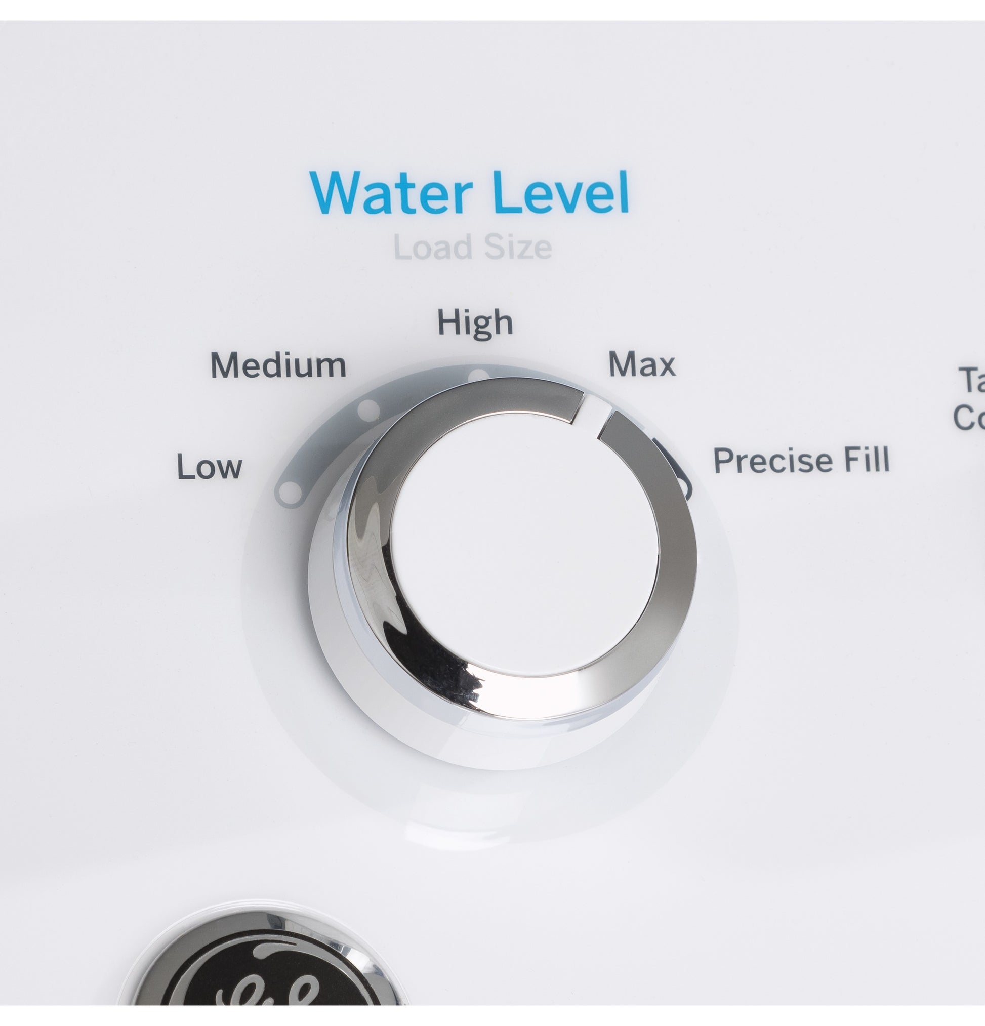 Close-up of water level control dial on washer with settings from low to max for load size adjustment