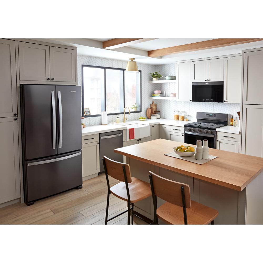Modern kitchen with gray cabinetry featuring a black air fry over-the-range microwave above a stainless steel gas range and refrigerator