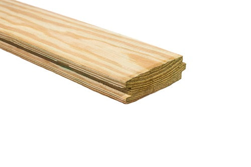 Close-up of treated wood plank with tongue and groove edges for home improvement projects