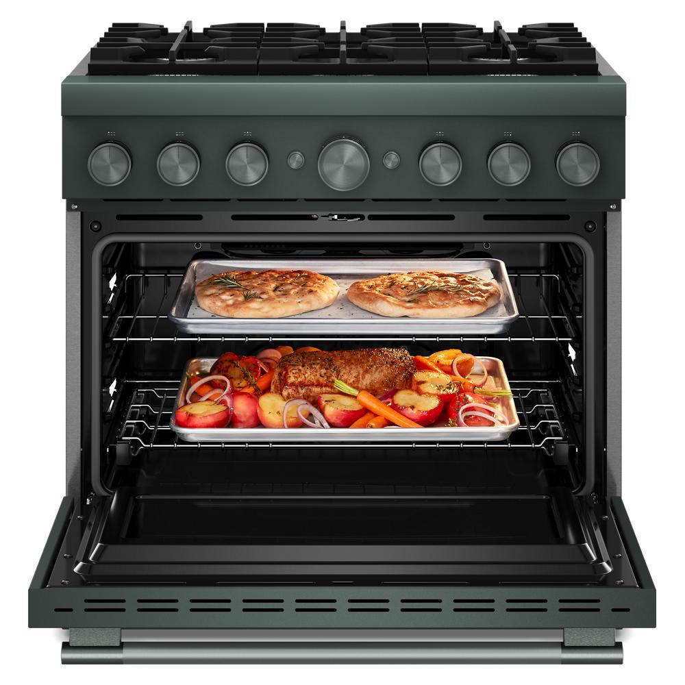 Open view of dark green six-burner dual fuel range from KitchenAid with food cooking inside oven racks