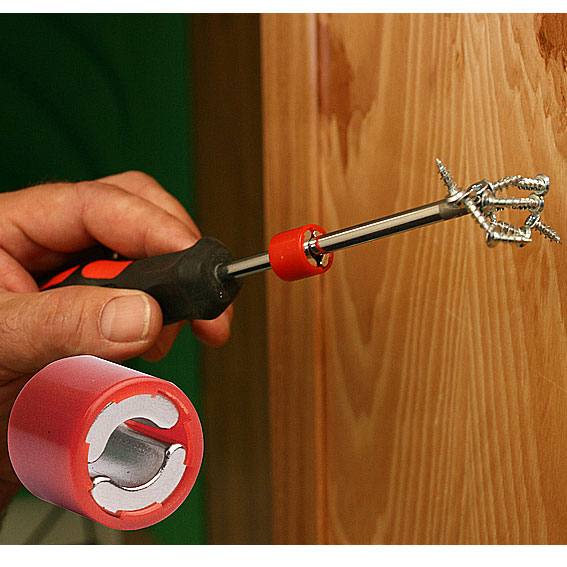 Hand holding screwdriver with tip magnet securing multiple screws for efficient tool use in home improvement tasks