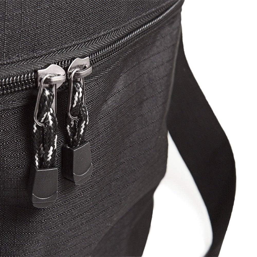 Close-up of black durable fabric bag zipper with braided pull cords and attached shoulder strap for outdoor gear transport