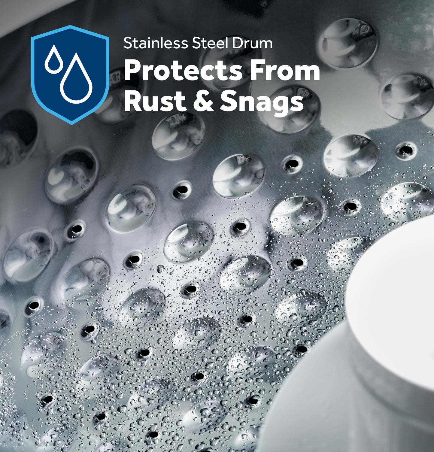 Close-up of stainless steel washer drum with water droplets emphasizing rust and snag protection feature