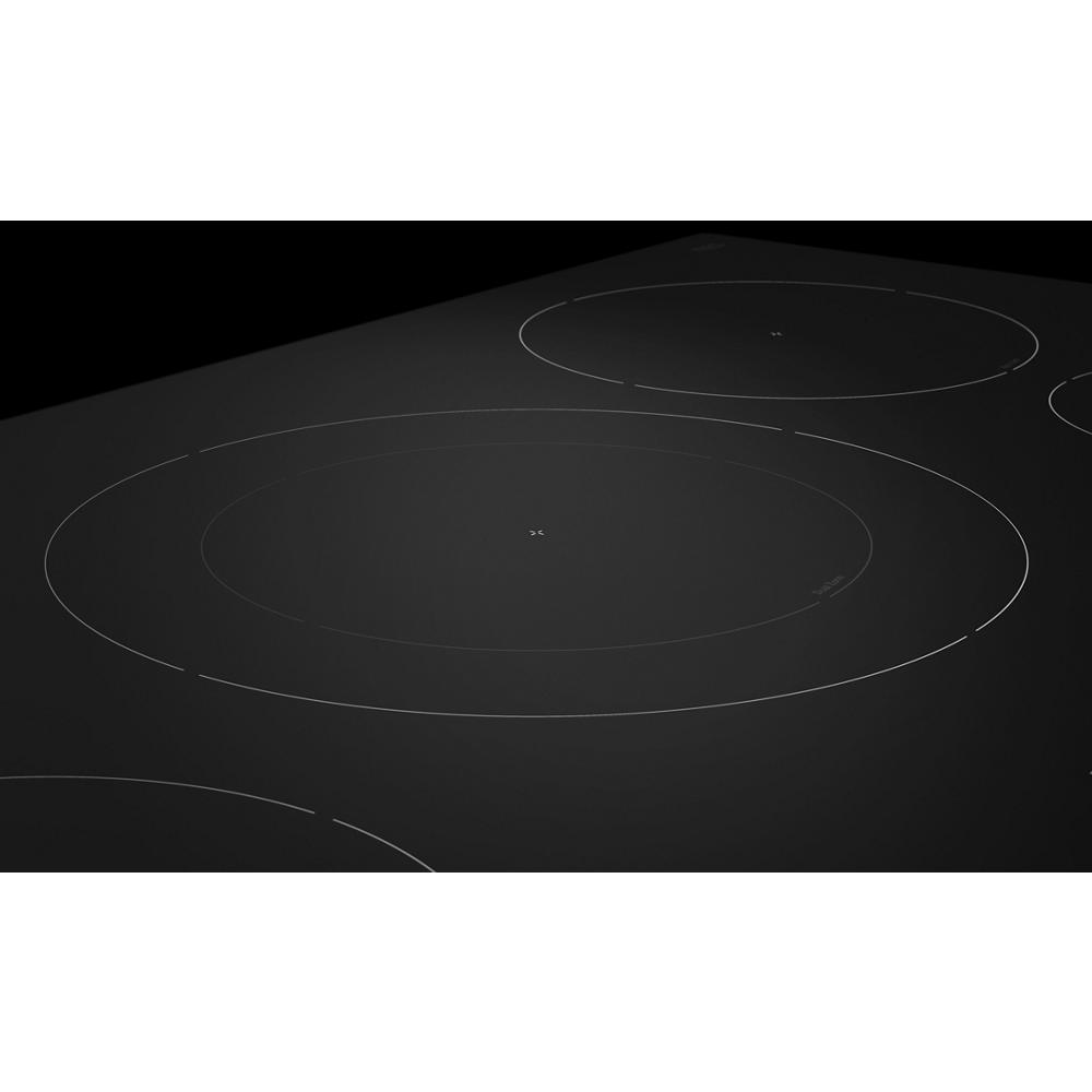 Close-up of a black 36-inch sensor induction cooktop with five heating zones in a modern kitchen setting