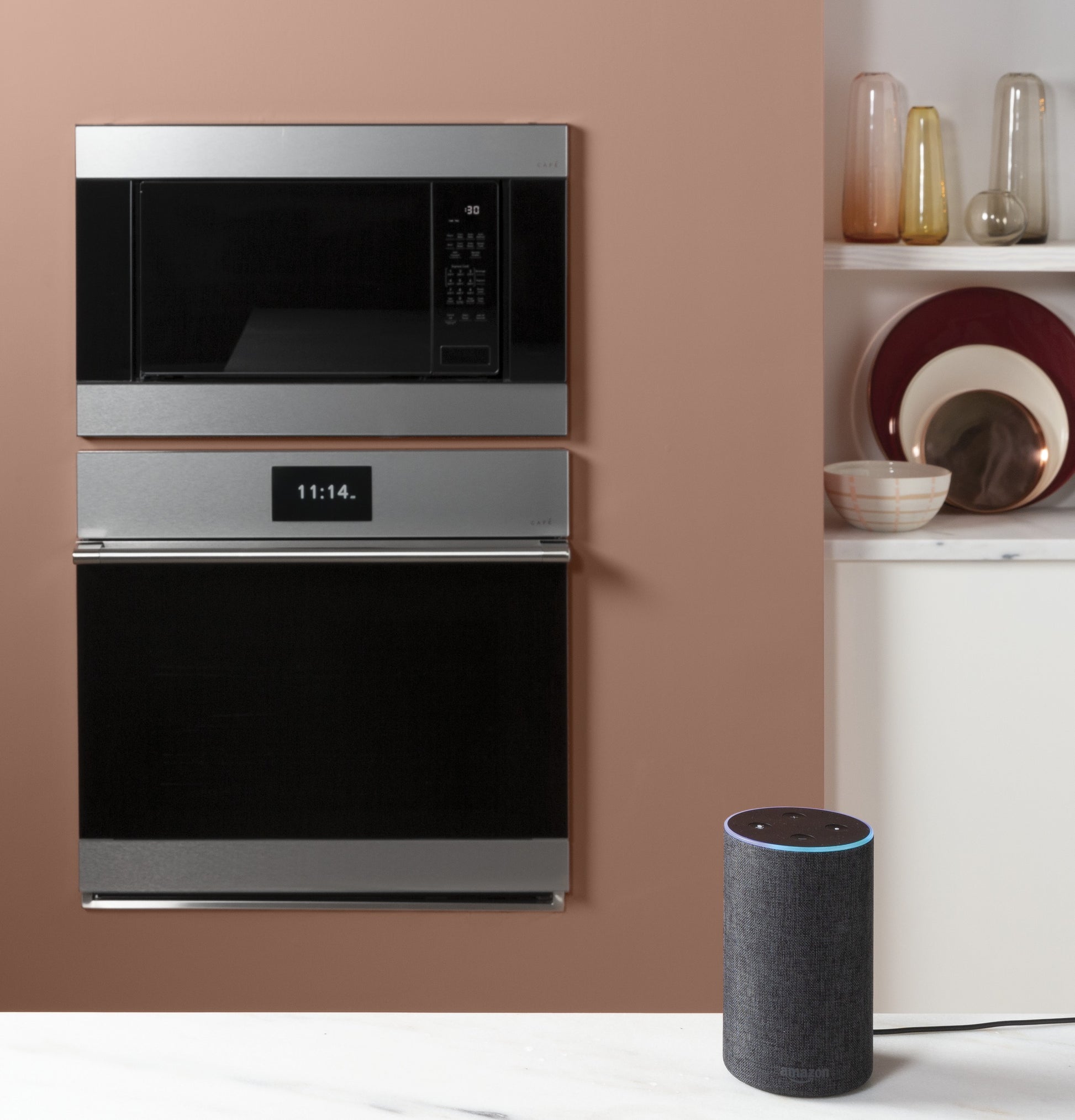 Modern stainless steel single wall oven with digital display and built-in microwave in a stylish kitchen setting