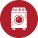 Red circular icon showing a simplified white washing machine, symbolizing laundry appliances and home improvement equipment.
