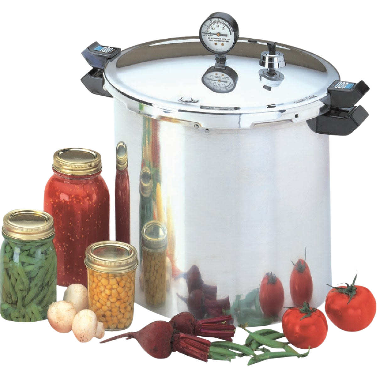 Large aluminum pressure cooker and canner with dial gauge and fresh vegetables and jars for home food preservation