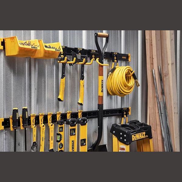 Black and yellow metal wall rails mounted with hooks holding hand tools, hose, and yellow storage bins for garage storage organization