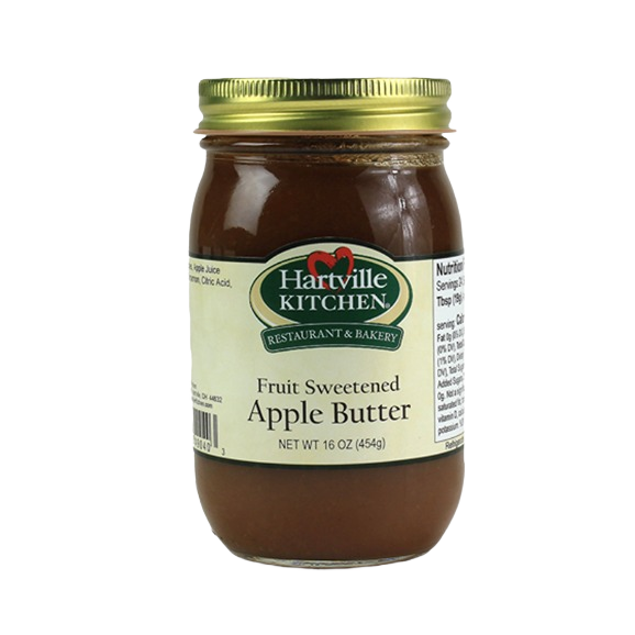 Glass jar of fruit sweetened apple butter with gold metal lid and Hartville Kitchen label on white background