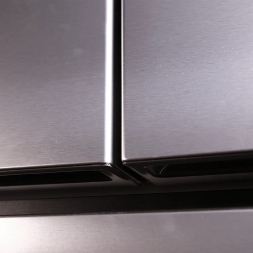 Close-up view of brushed stainless steel French door refrigerator edges with seamless modern design elements